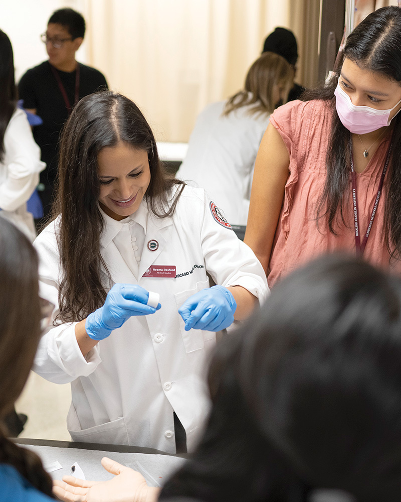 CMS student Reema Rashied leads a hands-on class for INSPIRE students.