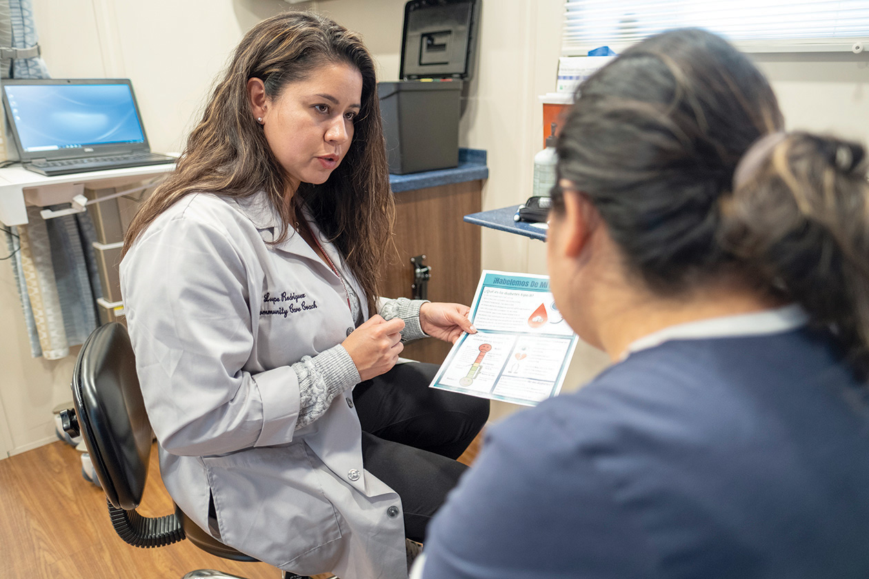 Community Care Director Lupe Rodriguez, APN, provides information in the Care Coach.