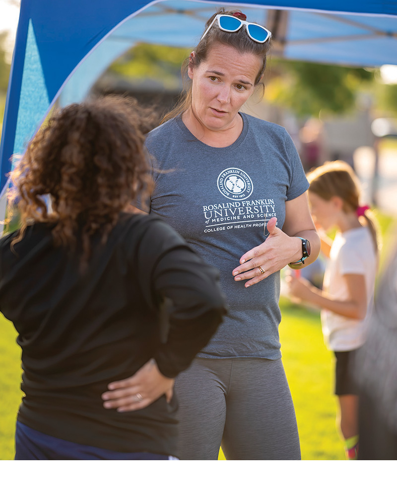 Dr. Sarah Haag gives physical therapy advice to a community member.