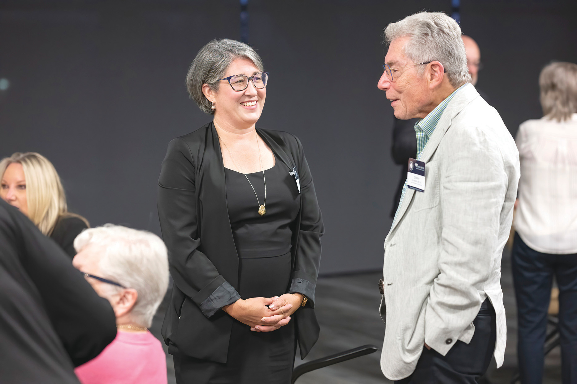 Amanda Simanek, PhD, MPH, talks with Denny Levinson, MD ’67, during the Michael Reese Scholarship dinner.