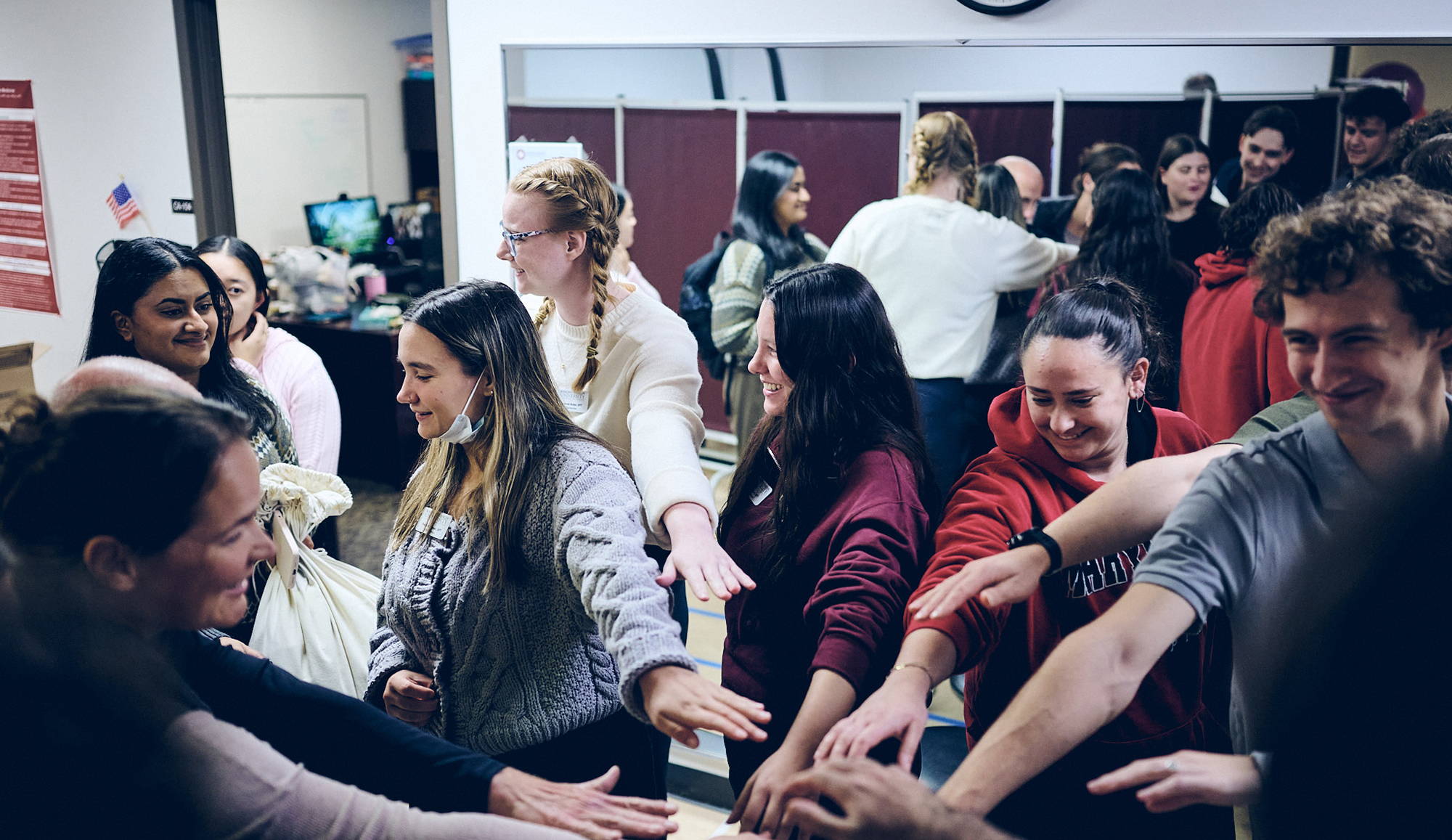 students with hands in a circle